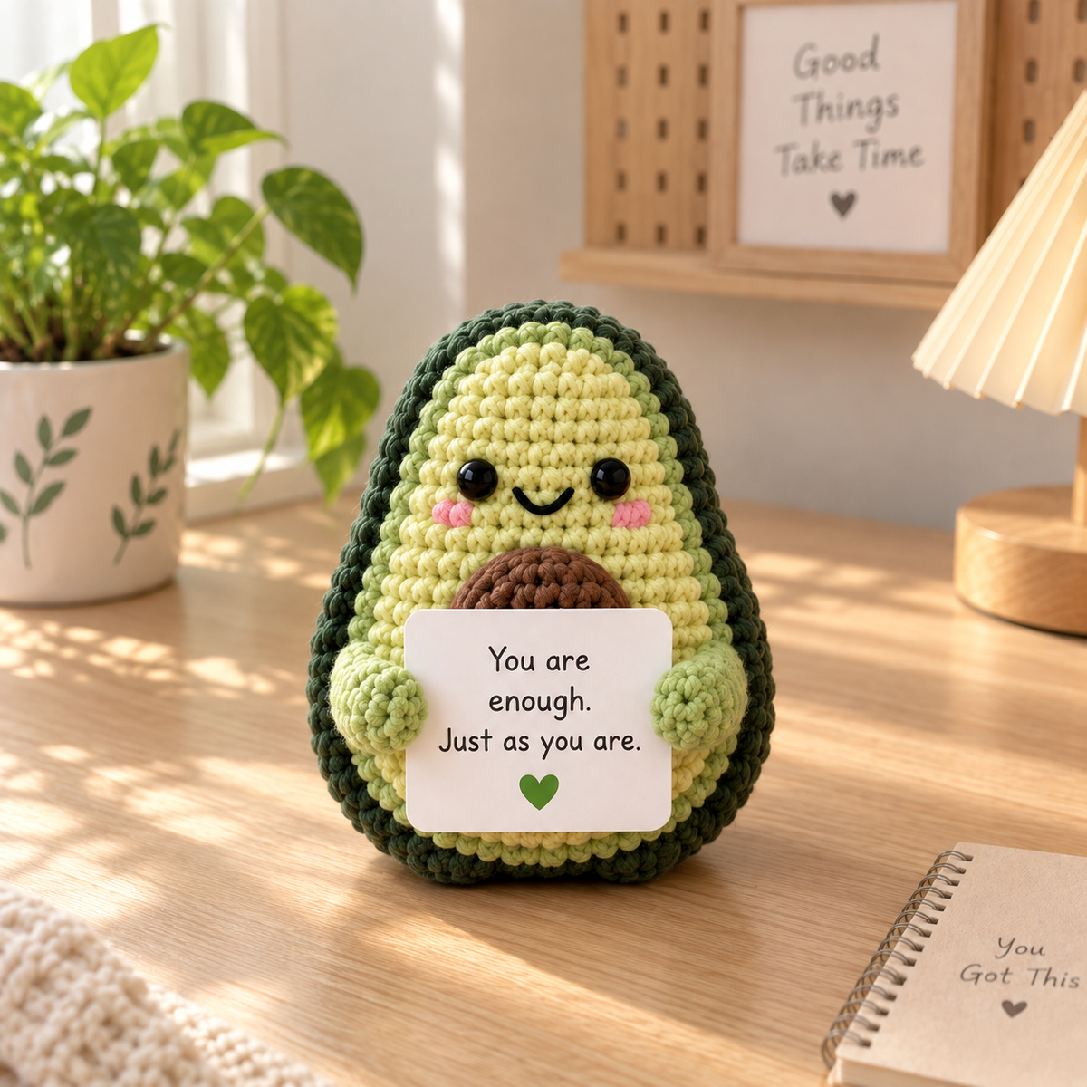 Avocado amigurumi emotional support character holding a custom message card