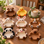 Nine crochet animal coasters featuring Bear, Duck, Frog, Cat, Bunny, Corgi, Panda, Cow, and Capybara