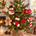 Seven crochet Christmas hanging ornaments displayed on a small tree, including Snowman, Christmas Tree, Hot Cocoa Mug, Gingerbread, Stocking, Wrapped Gift, and Candy Cane