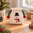 Snowman crochet drawstring pouch with green cords and festive pom pom ends