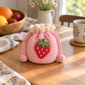Strawberry crochet drawstring pouch in pink with handmade strawberry detail
