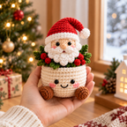 Santa crochet plant decor held in hand in a warm Christmas room