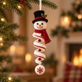 Classic Top Hat crochet snowman spiral ornament hanging beside Christmas tree lights