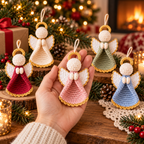 Blush crochet angel ornament held by hand with other angel colors displayed nearby