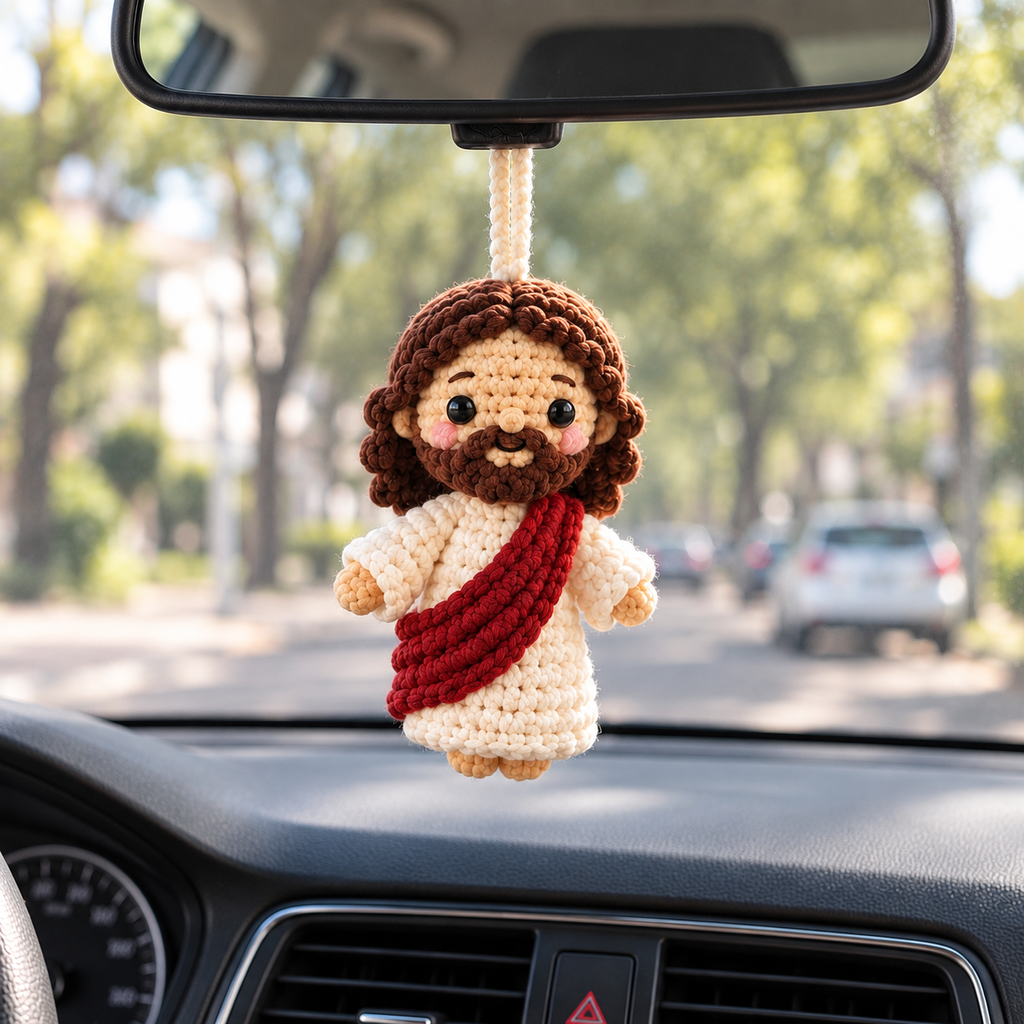 Jesus Blessing crochet car hanging displayed from a rearview mirror inside a car