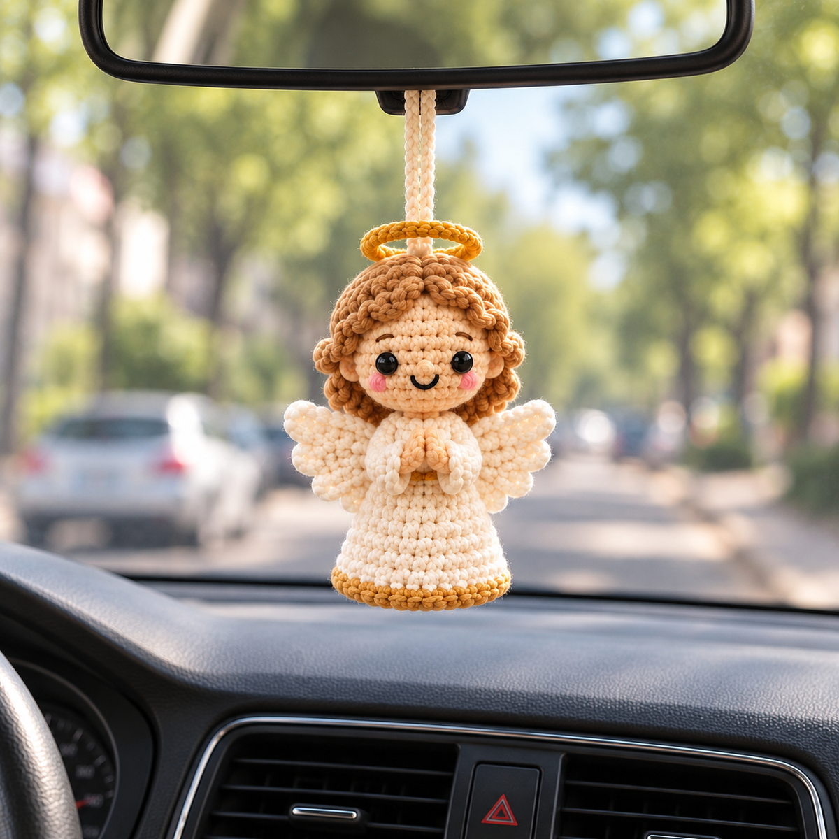 Guardian Angel crochet car hanging displayed from a rearview mirror inside a car