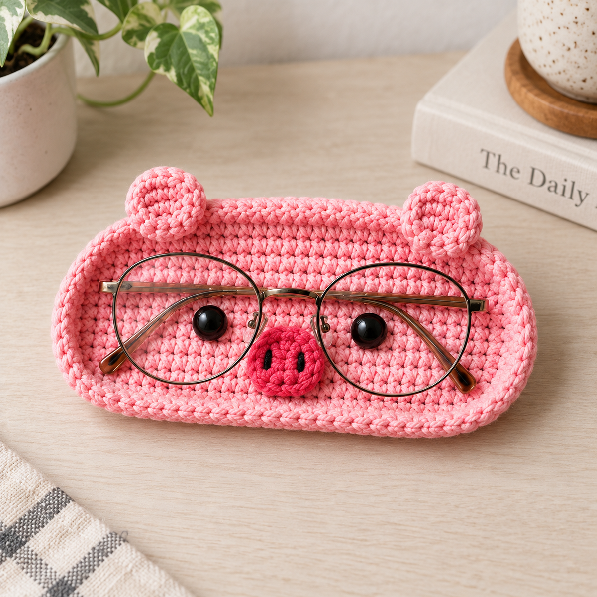 Pink Piggy crochet glasses holder with rounded ears, crochet snout, rosy cheeks, and eyeglasses