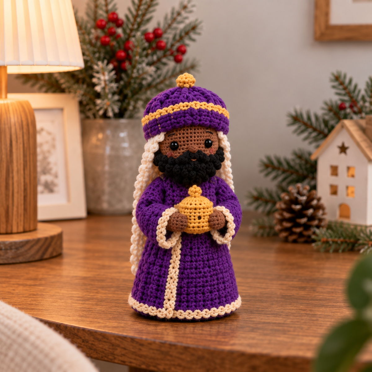 Handmade crochet Wise Man in purple robe holding a gift