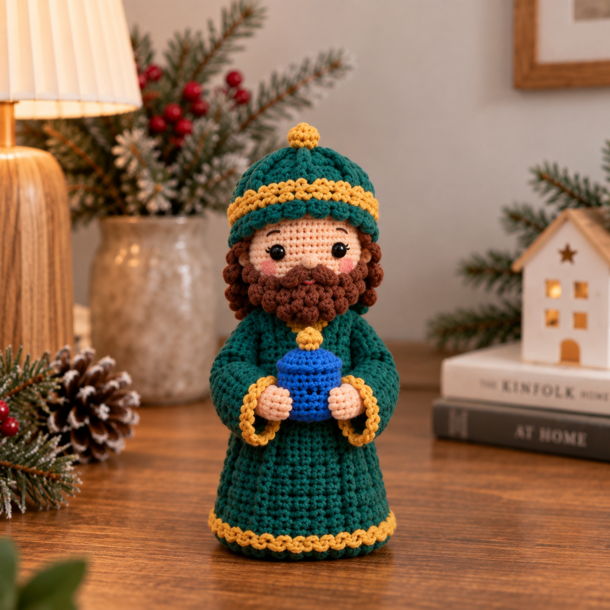 Handmade crochet Wise Man in green robe holding a gift